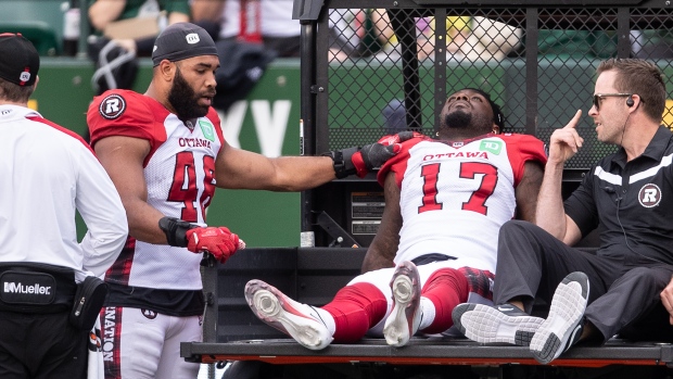 Devonte Dedmon leaves field on a cart